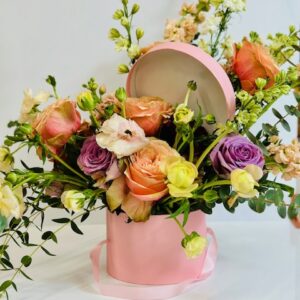 Hat box floral arrangement with seasonal flowers
